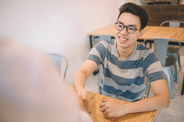 International student shaking hands with a professional during a successful job interview, representing career placement and global success.